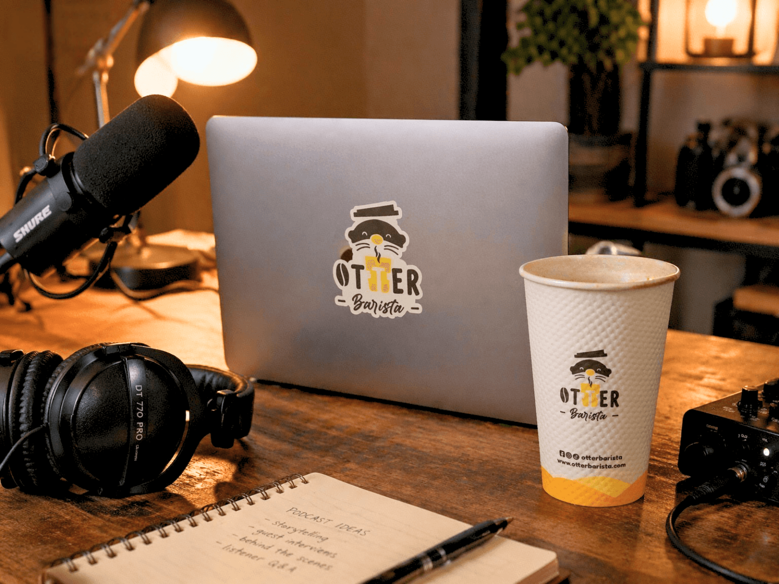 A podcast recording setup — microphone and headphones on a wooden surface