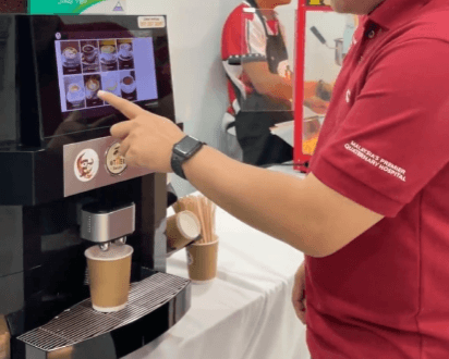 Sleek Otter robotic barista dispensing specialty coffees from a polished station at a corporate banquet hall during a business networking event.
