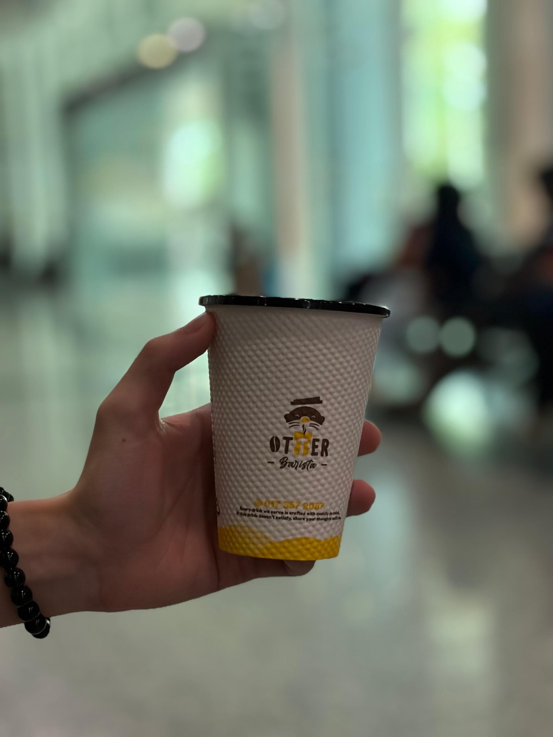 An Otter robotic barista machine positioned in a modern office lobby, serving employees during morning rush hour without installation fees.